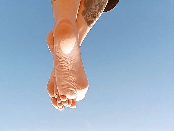 Clouds and sexy salty sea feet of Dominatrix Nick. Soles fetish